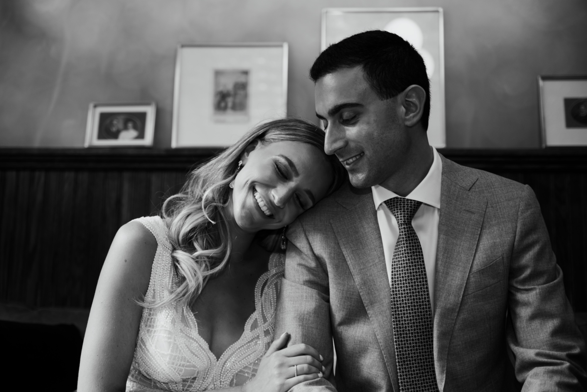 Bride leaning on groom direct gaze