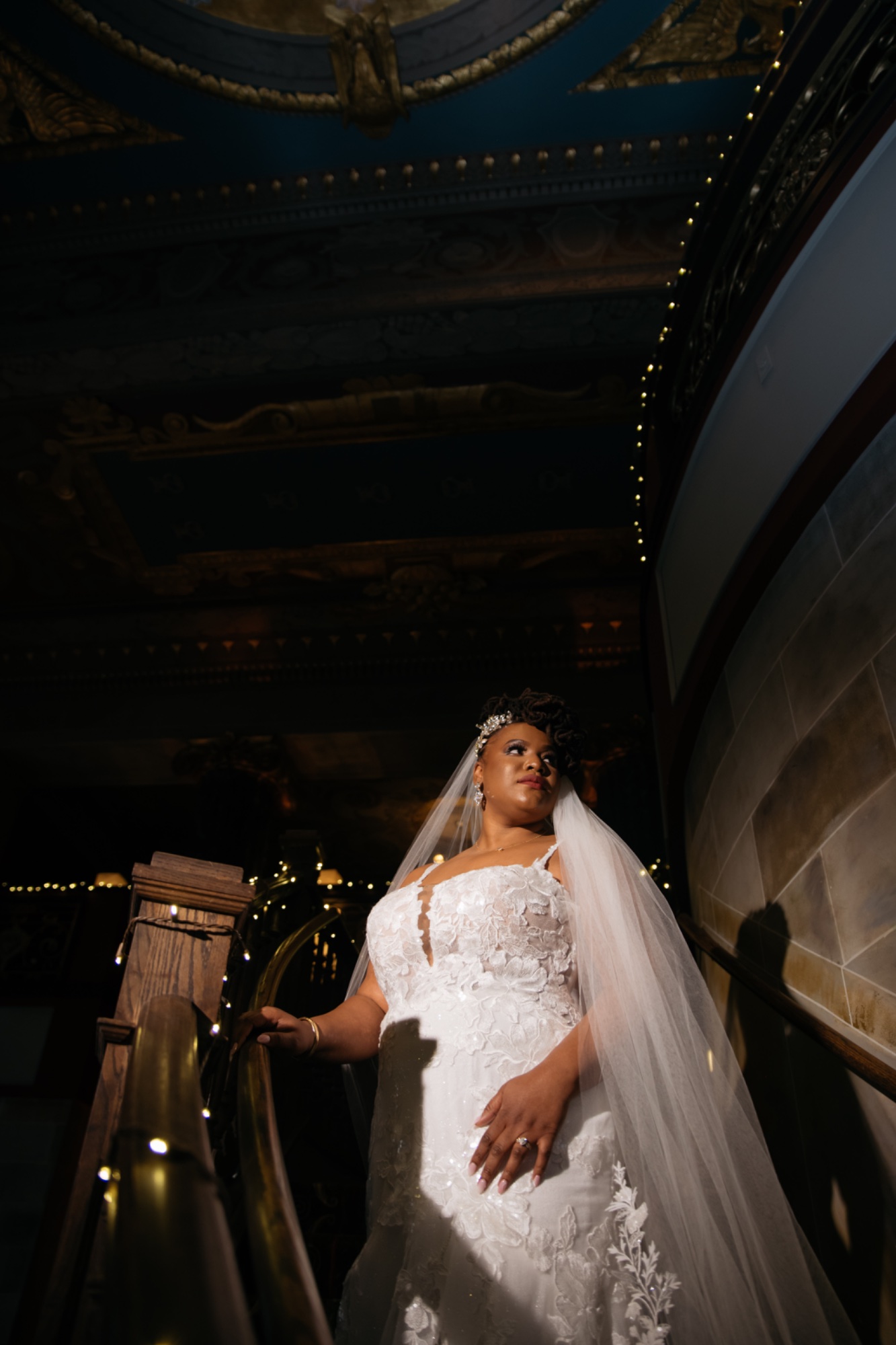 Bride on staircase painted ceiling