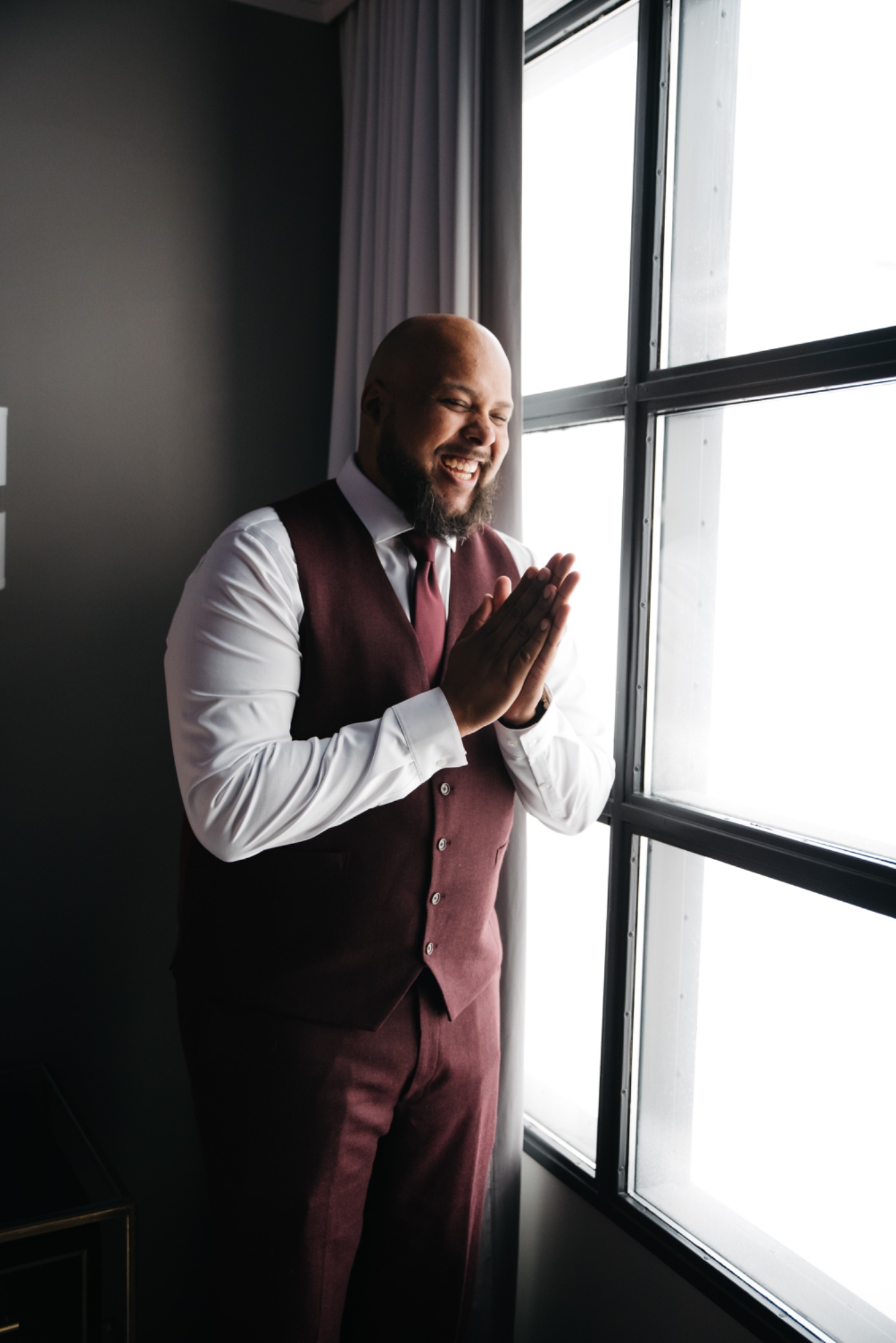 Groom laughing at window